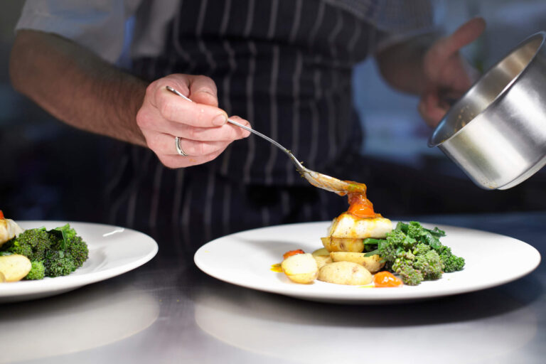 Chef adds finishing touches to a meal