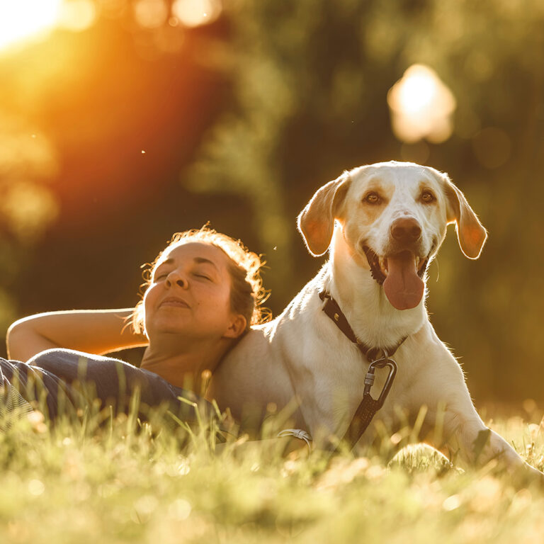 Woman relaxing outside with dog